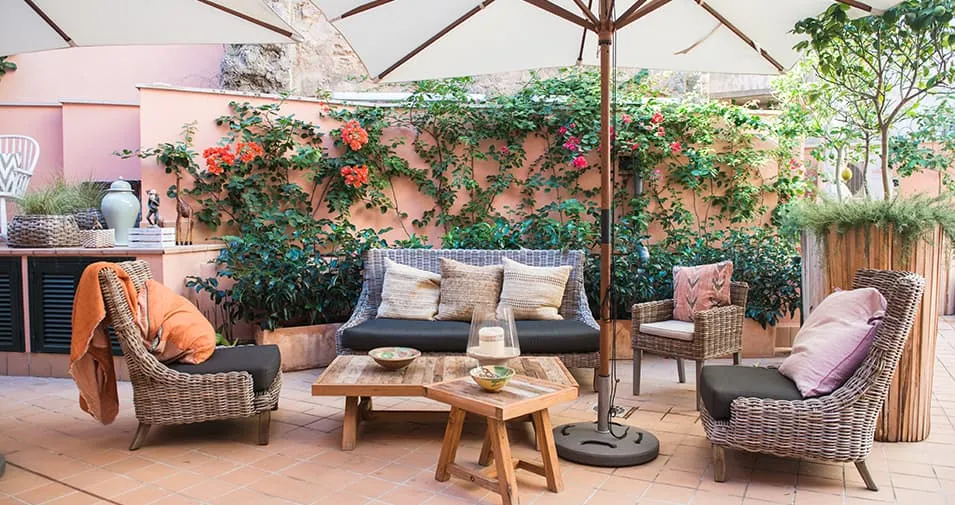 Terraza ajardinada de la cafetería Ziva en Palma con sofás de fibra